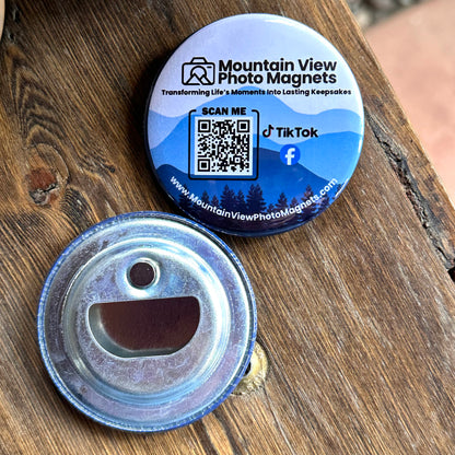 Round metal bottle opener with QR code and branding on a wooden surface