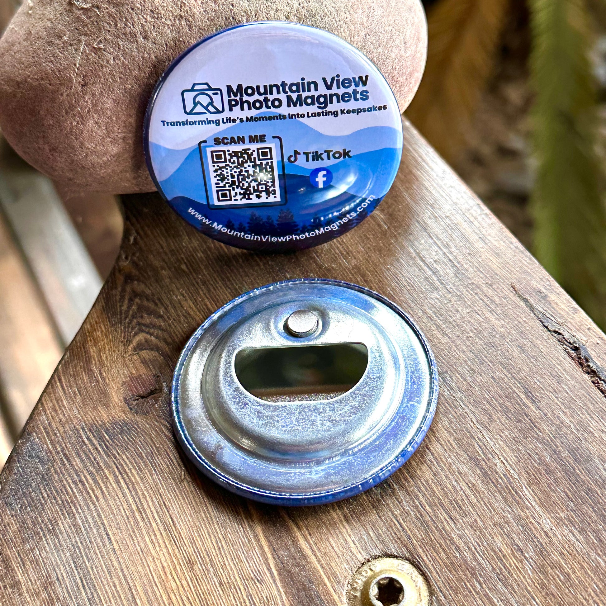 Round bottle cap opener with blue rim on a wooden surface, featuring Mountain View Photo Magnets branding.