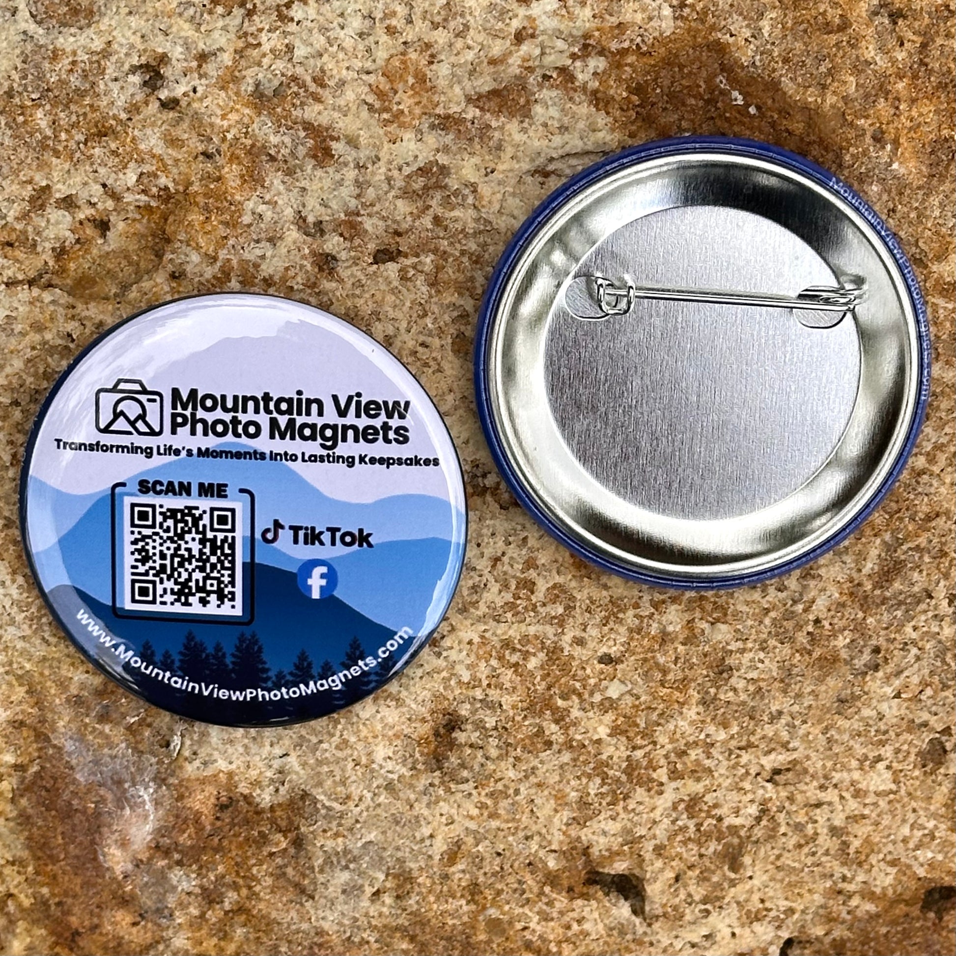 Button badge with QR code and branding on a textured surface.