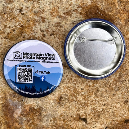 Button badge with QR code and branding on a textured surface.
